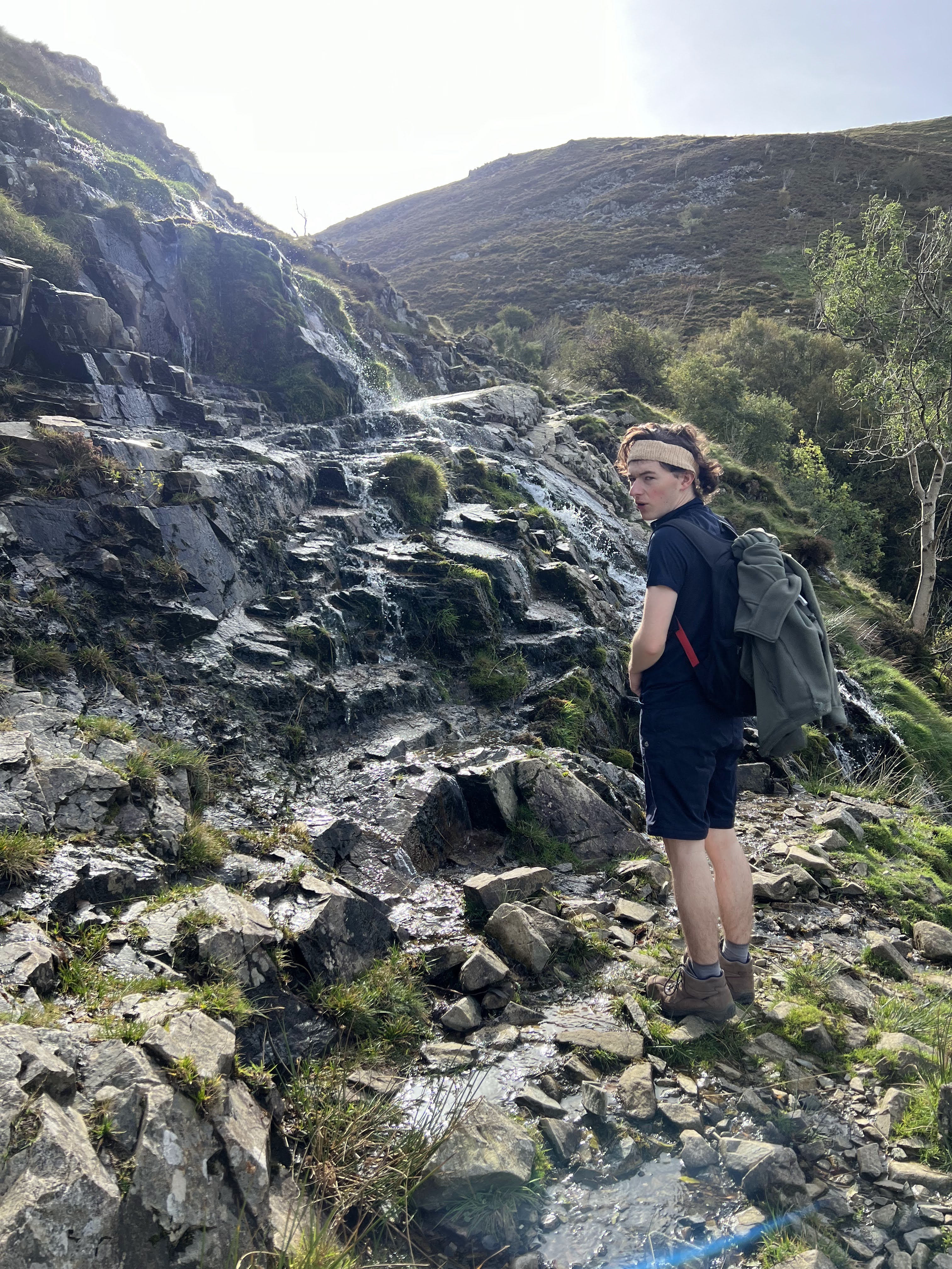 Nick looking confused at the camera as the footpath ahead is steep with water flowing on it