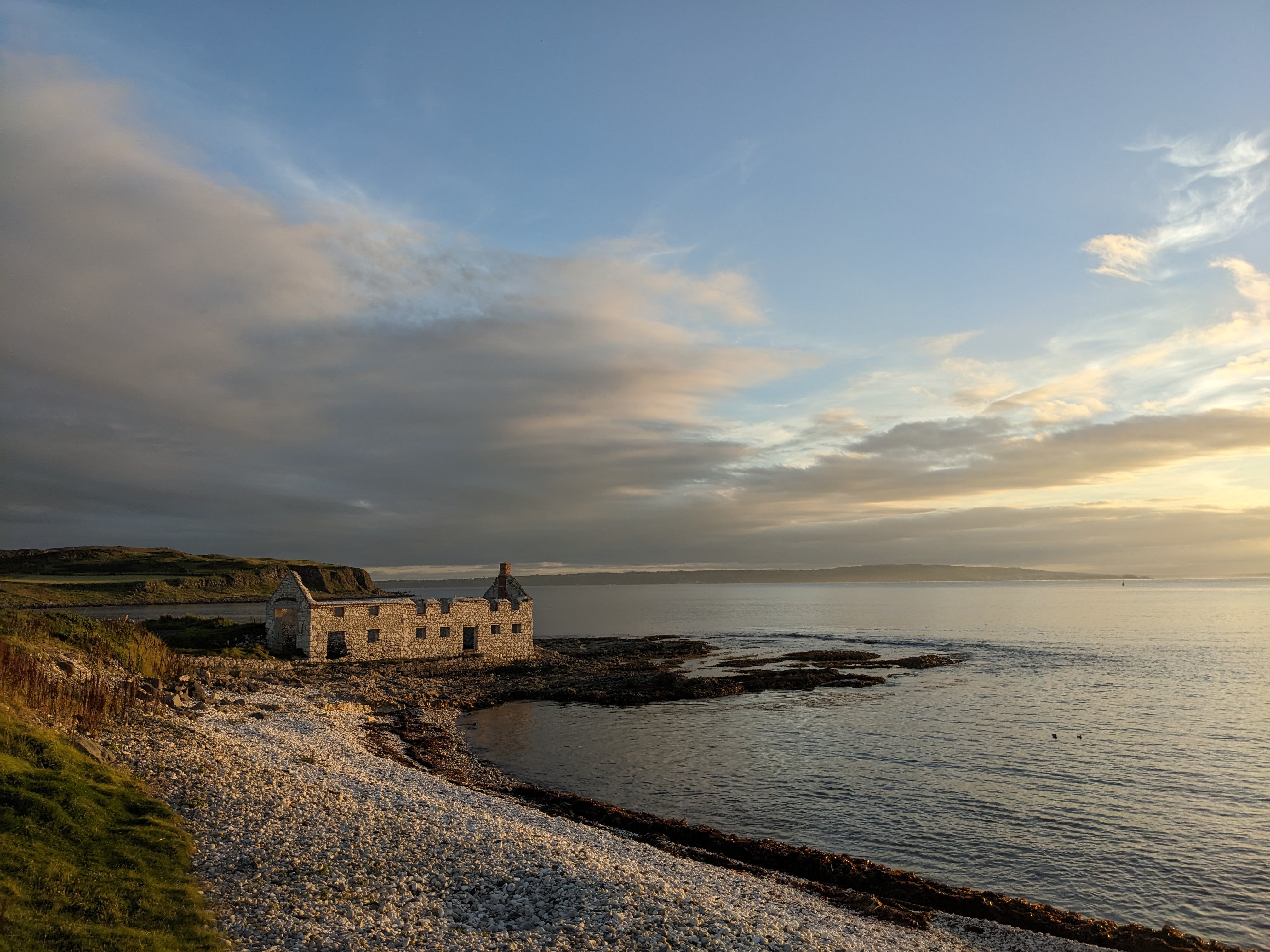 A sunset view of a pebble beach