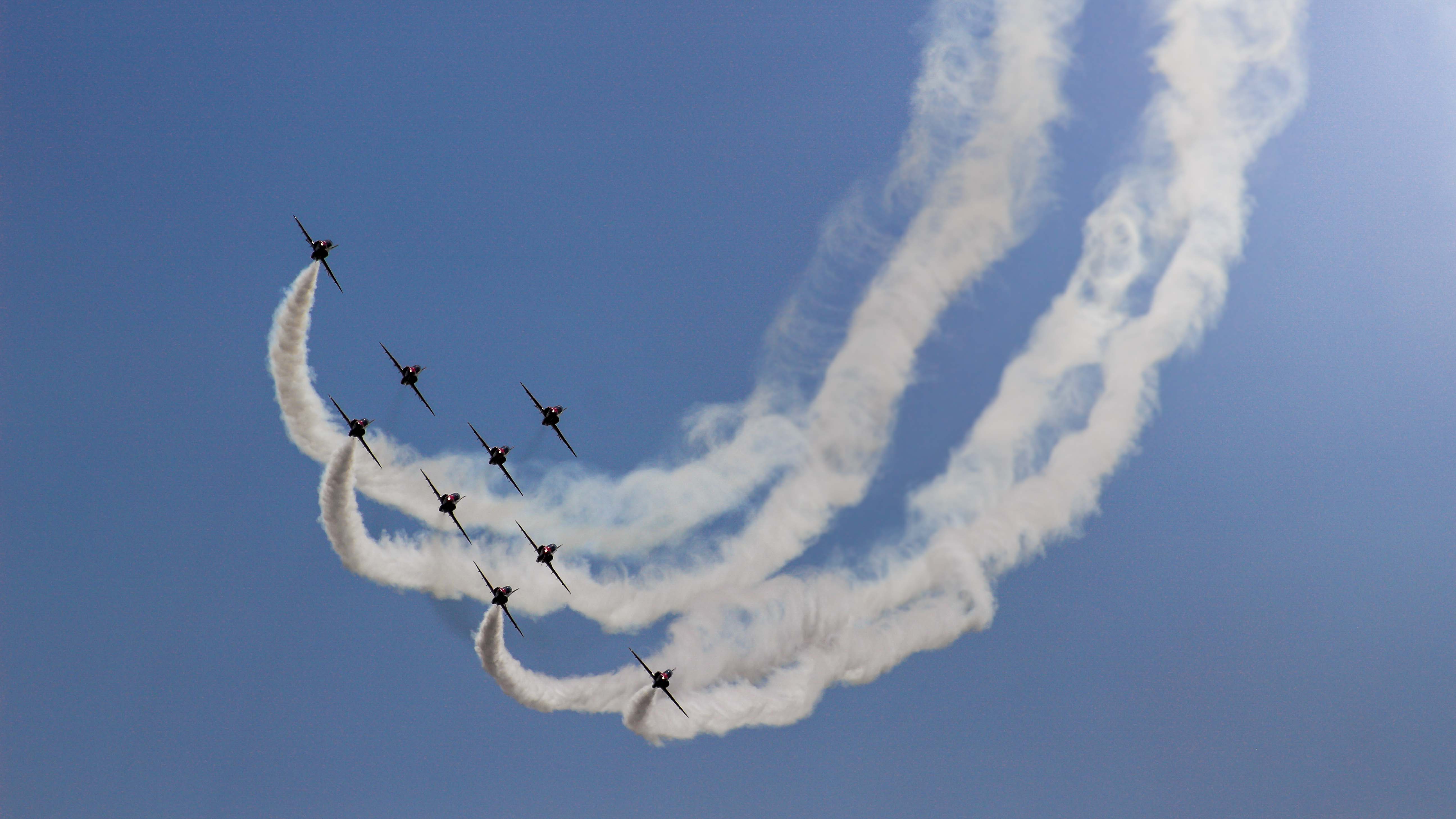 The red arrows flying in formation with smoke trails